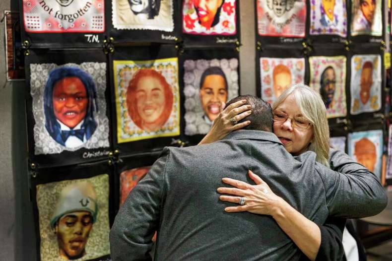 Sandy Phillips embraces Javier Cazares during a quiet moment before the National Vigil for All Victims of Gun Violence at St. Mark's Episcopal Church in Washington, D.C. on Wednesday. Phillips, a San Antonio resident, lost her daughter Jessica Redfield Ghawi in a July 2012 mass shooting at a movie theater in Aurora, Colorado.