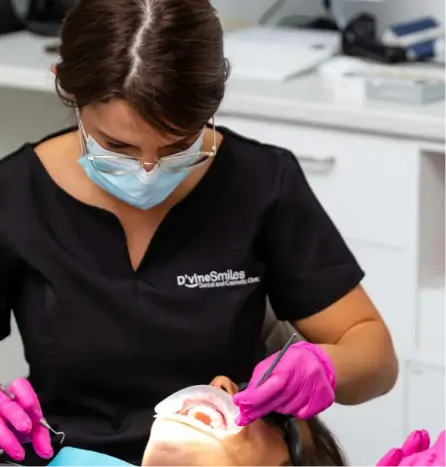 Emergency dentist at D'vine Smiles Melbourne providing urgent dental care to a patient in a clinical setting