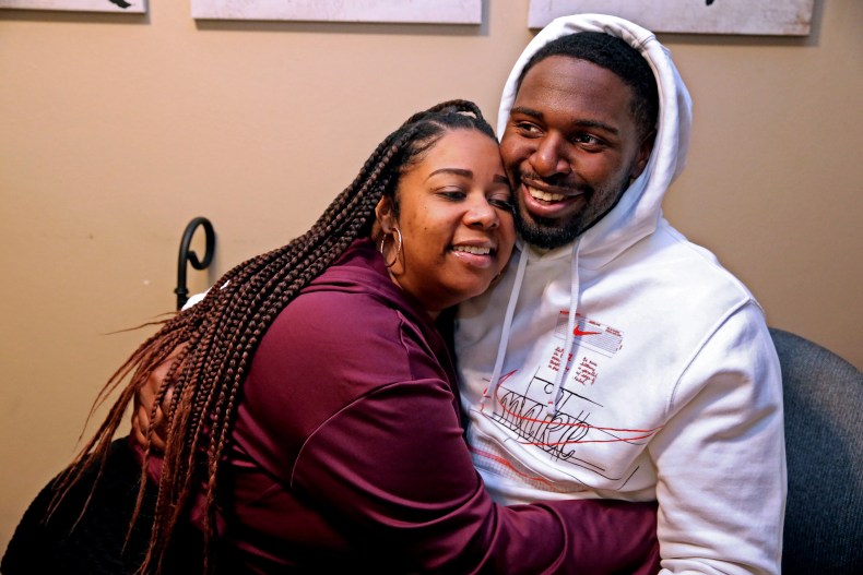 Tyanna Cates gives Marlin Dixon a hug at their Menomonee Falls apartment. The two met after Dixon's release from prison. Though their backgrounds are dissimilar, they quickly built a relationship.